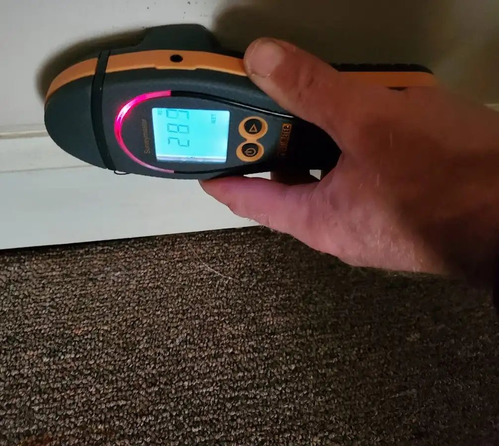 Moisture detection at baseboard during Storm Damage Restoration in Drexel Heights